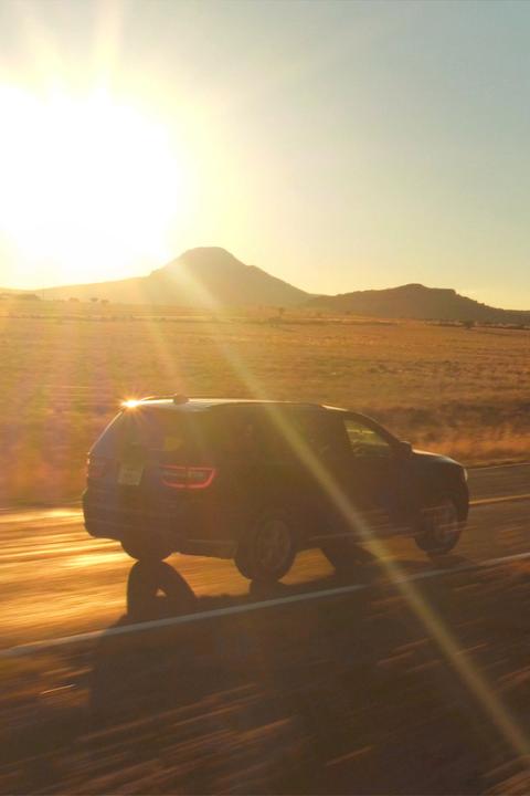 SUV driving down country road